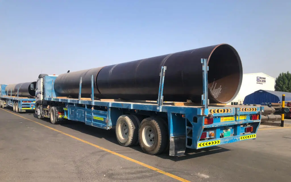 Huge 60" pipes loaded on a flat bed truck inside Trouvay & Cauvin Jebel Ali yard.